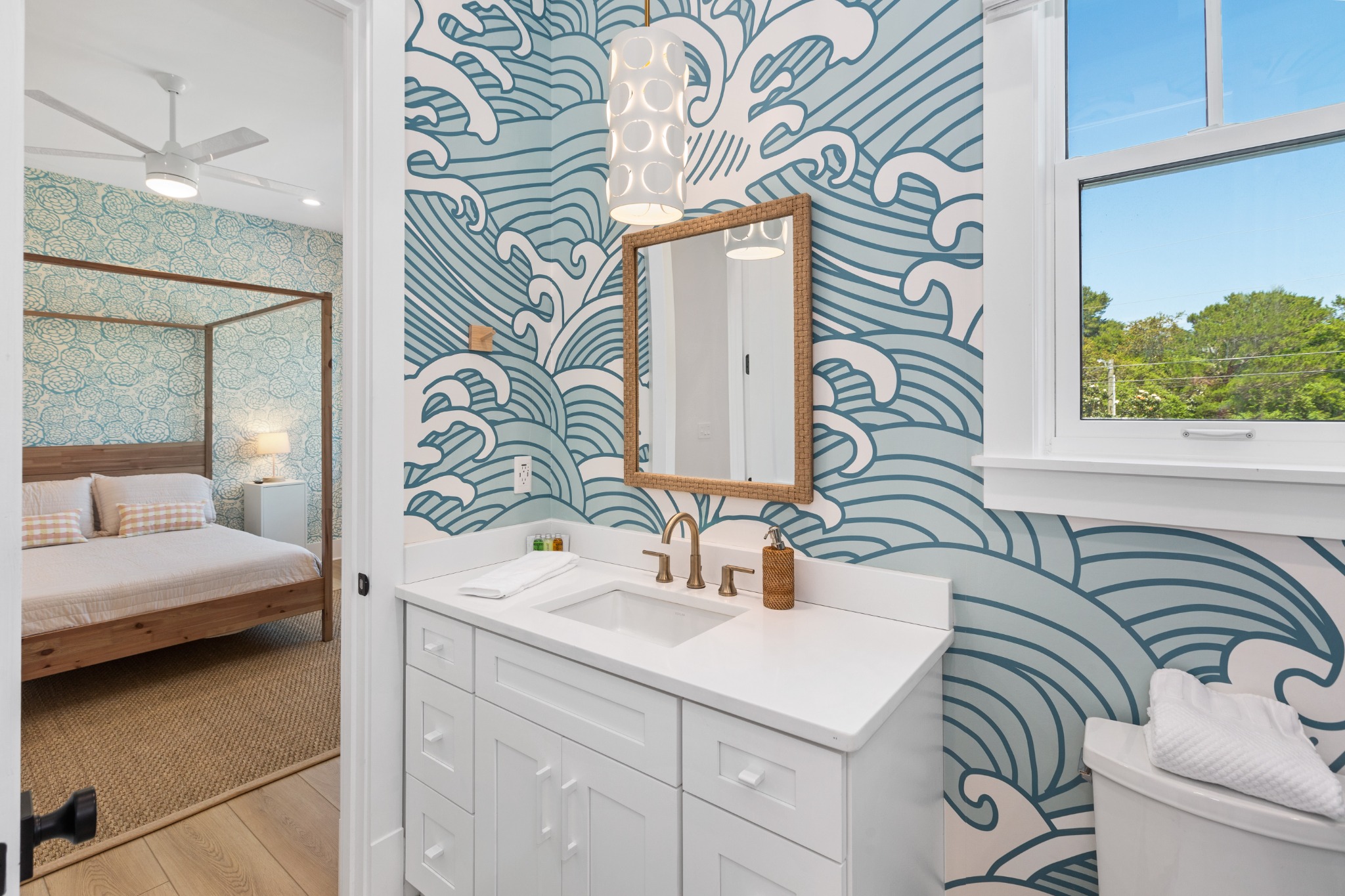 Bathroom with floral wallpaper and dual vanity