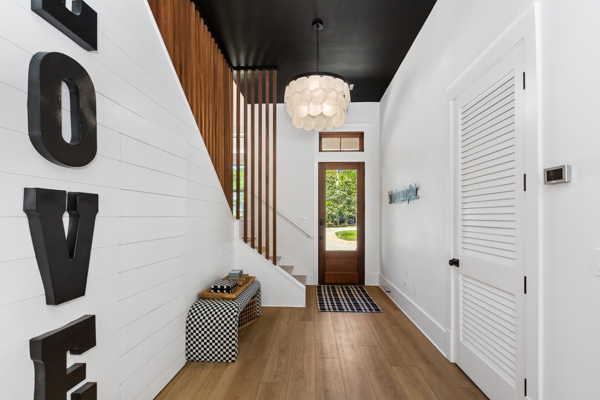 Vaulted living room with LOVE mural